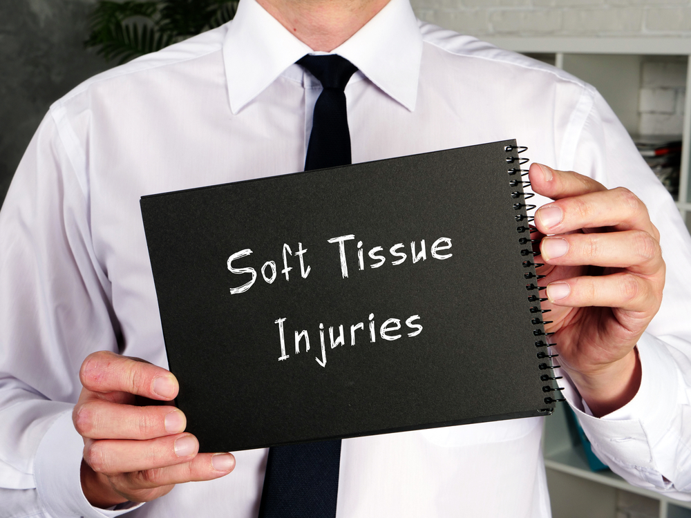 doctor holding up a soft tissue injury sign